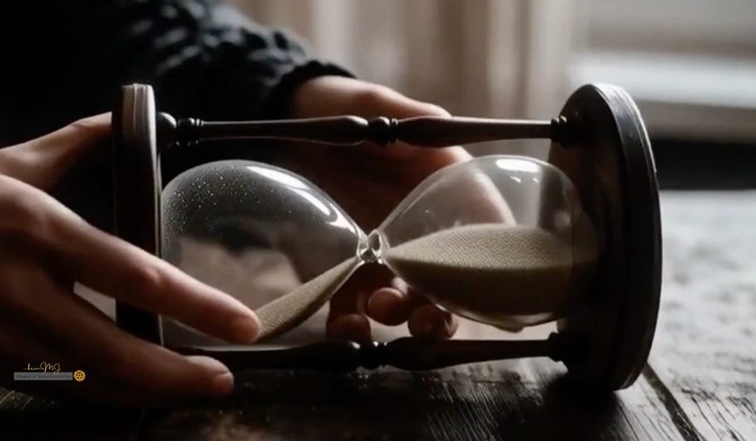 A close-up cinematic shot of an hourglass turned flat on its side on a dark wooden table, illustrating how to practice nervous system regulation during the silence penalty.